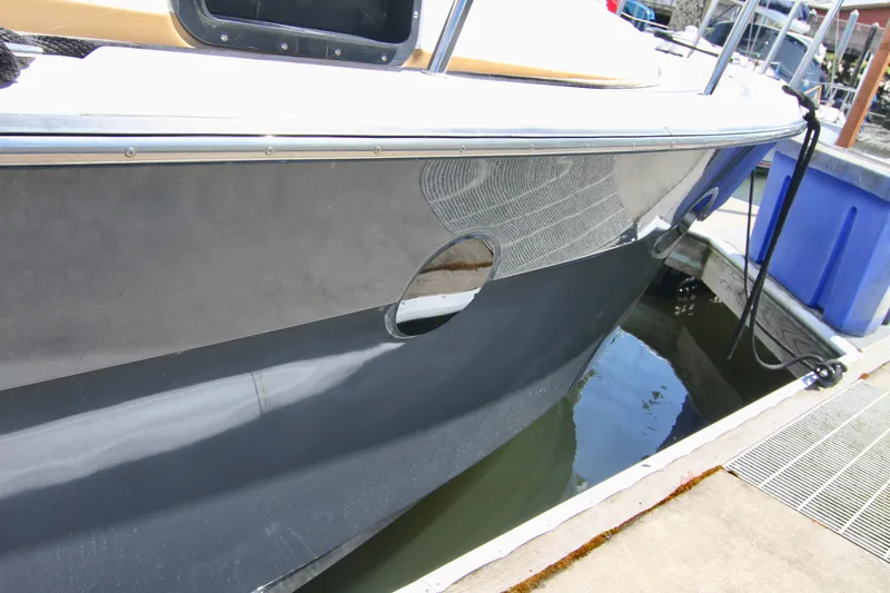  Yacht Photos Pics 2020 Ranger Tugs R-29 boat docked at marina, close-up of hull and waterline.