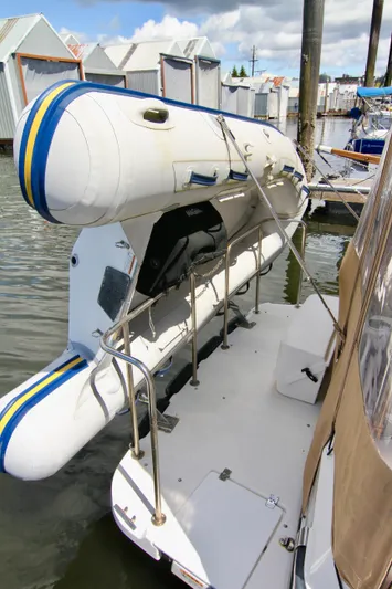  Yacht Photos Pics Ranger Tugs R-29 2020 model with mounted inflatable dinghy at a marina.