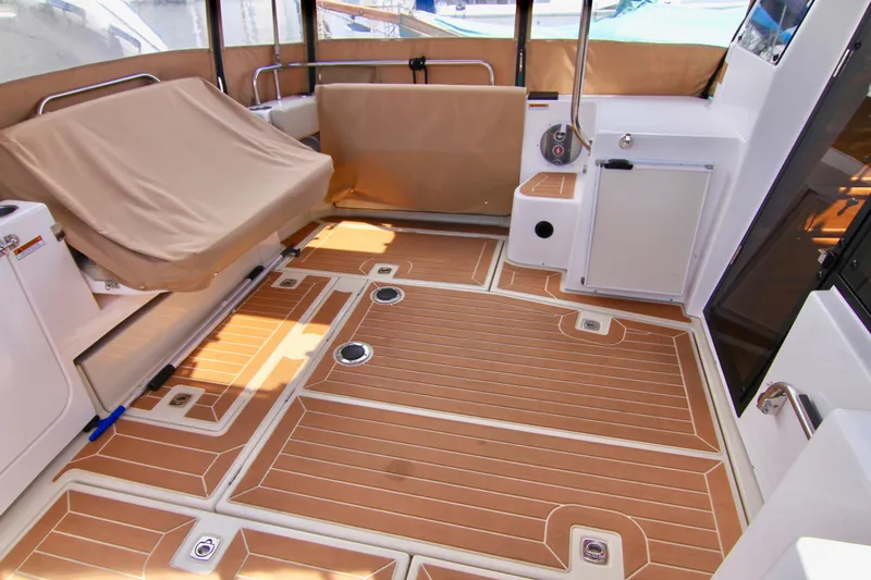  Yacht Photos Pics 2020 Ranger Tugs R-29 boat interior with teak flooring and covered seating.