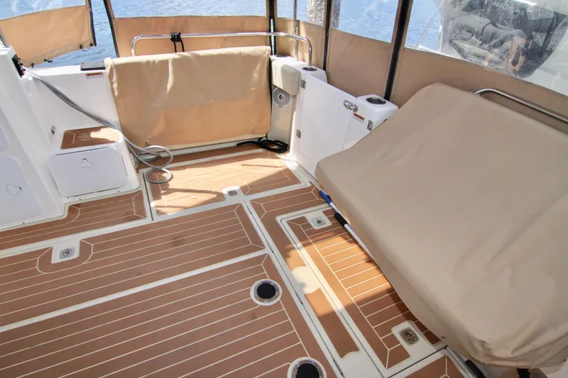  Yacht Photos Pics Spacious deck area of 2020 Ranger Tugs R-29 with cushioned seating and wood-like flooring.