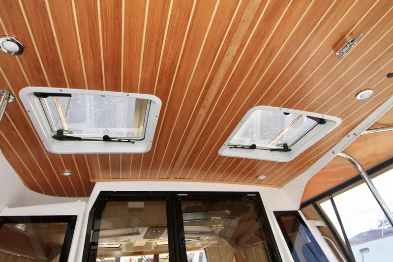  Yacht Photos Pics Wood-paneled ceiling with skylights in 2020 Ranger Tugs R-29 boat interior.