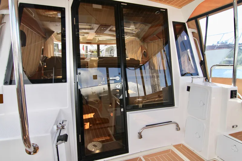  Yacht Photos Pics 2020 Ranger Tugs R-29 interior view with glass door and wooden accents.