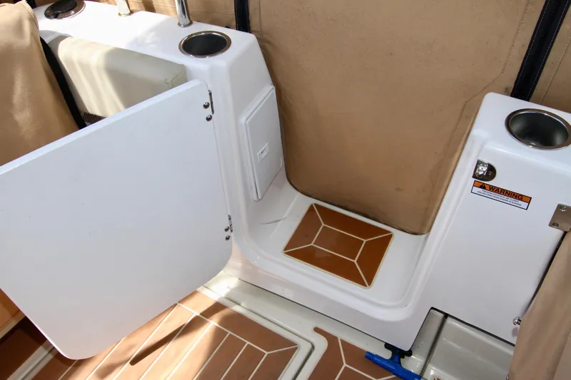  Yacht Photos Pics 2020 Ranger Tugs R-29 boat interior with open storage compartment and cup holders.