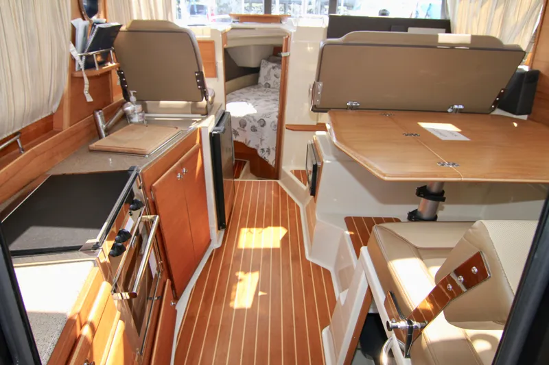  Yacht Photos Pics 2020 Ranger Tugs R-29 interior with wood flooring and modern amenities.