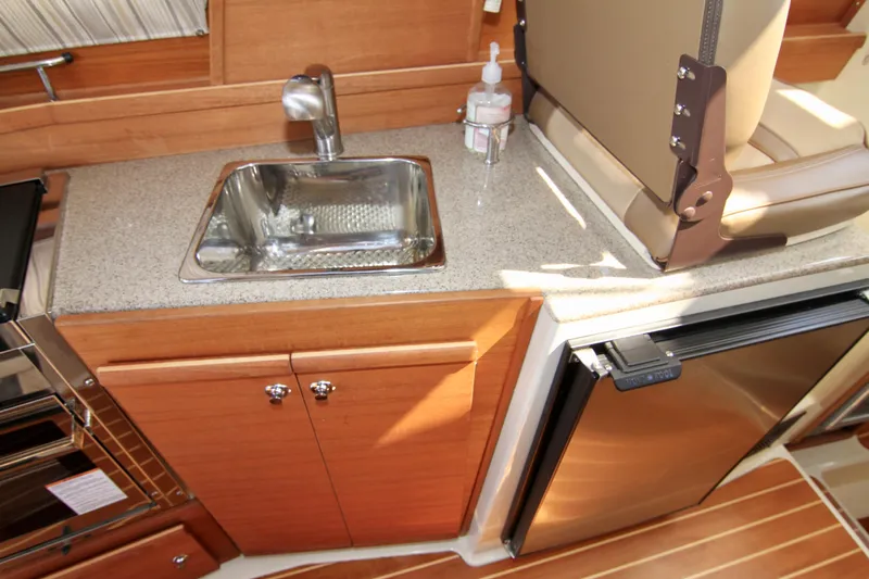  Yacht Photos Pics 2020 Ranger Tugs R-29 galley with sink, countertop, and stainless steel refrigerator.