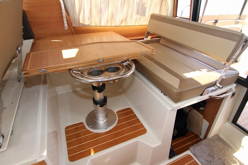  Yacht Photos Pics Interior of 2020 Ranger Tugs R-29 with convertible dinette and wooden flooring.