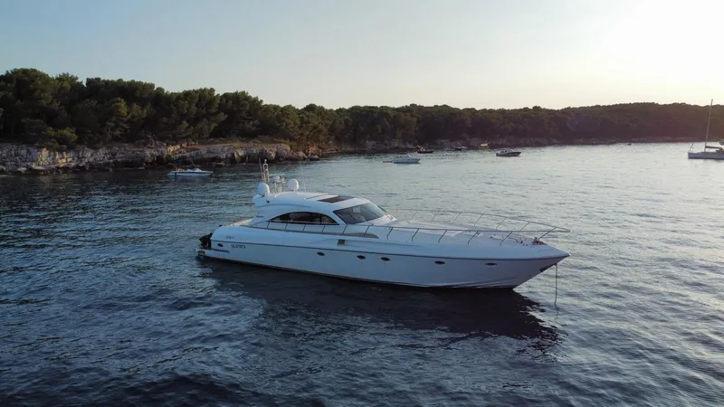  Yacht Photos Pics 2006 Rizzardi 73 yacht anchored in a serene coastal bay.