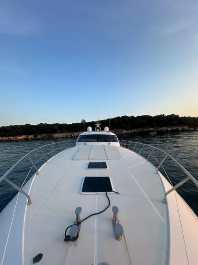 Yacht Photos Pics 2006 Rizzardi 73 yacht on calm water at sunset, showcasing sleek deck design.
