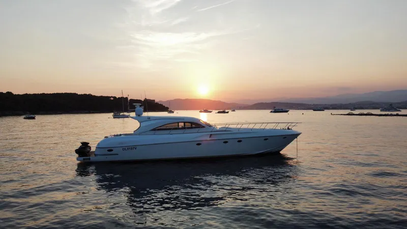  Yacht Photos Pics Luxury 2006 Rizzardi 73 yacht at sunset on tranquil waters.