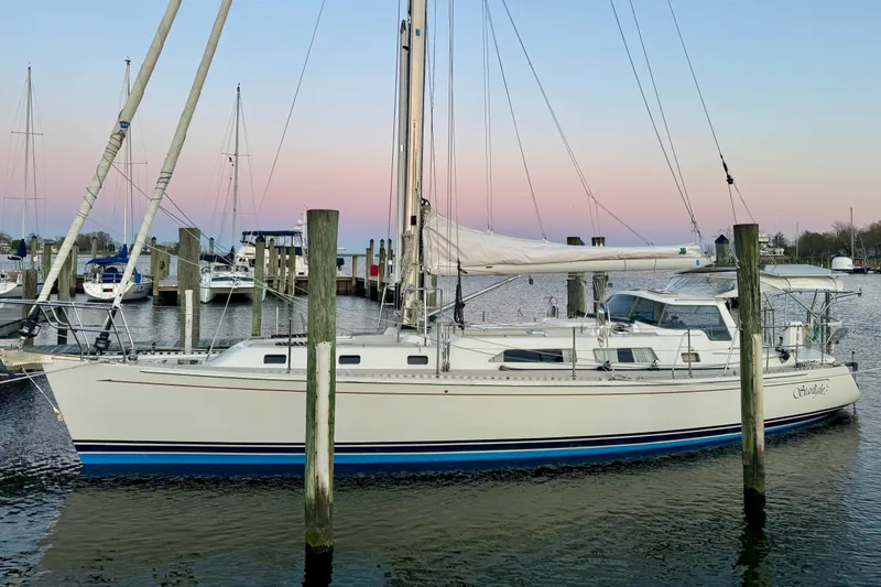 Starlight Yacht Photos Pics 2016 Outbound 46 sailboat docked at marina during sunset.