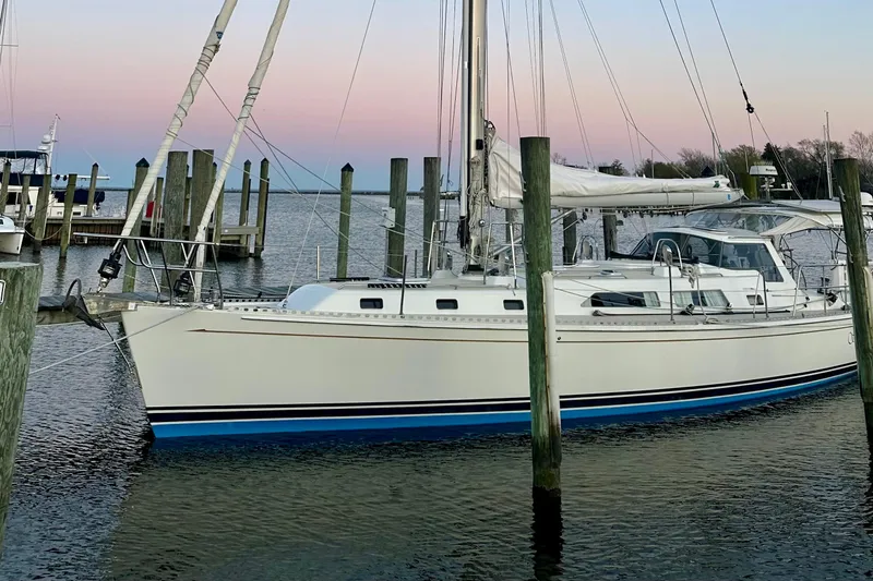 Starlight Yacht Photos Pics Sailboat docked at marina during sunset, Outbound 46 model, 2016.