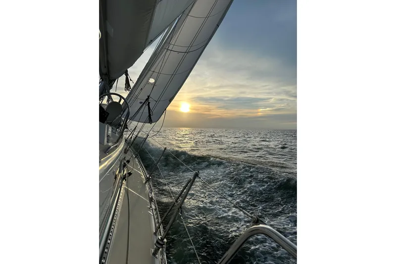Starlight Yacht Photos Pics Sailing on 2016 Outbound 46 yacht at sunset over the ocean.