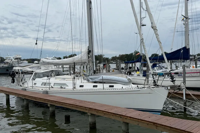 Starlight Yacht Photos Pics Sailboat docked at marina, Outbound 46 model, 2016, with overcast sky.