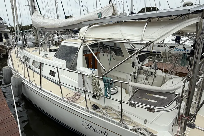 Starlight Yacht Photos Pics Sailboat docked at marina, 2016 Outbound 46 model, featuring sleek design and spacious deck.