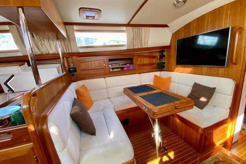 Starlight Yacht Photos Pics Luxurious interior of 2016 Outbound 46 yacht with cozy seating and elegant wood finish.