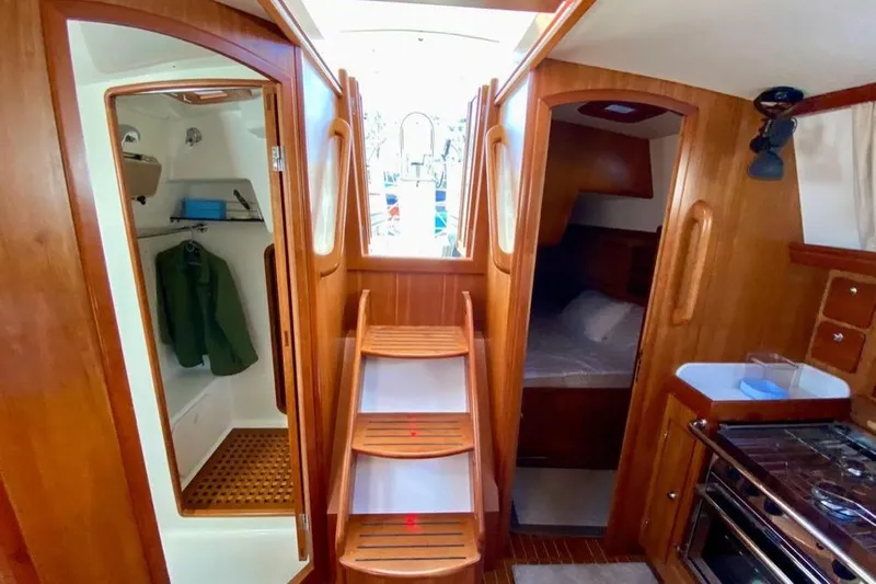 Starlight Yacht Photos Pics Interior of 2016 Outbound 46 yacht with wooden finish, showing cabin and galley.