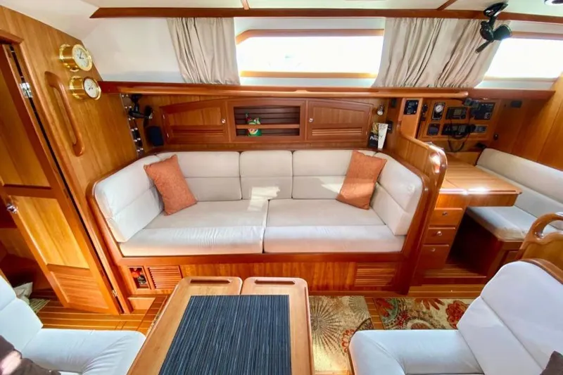 Starlight Yacht Photos Pics Luxurious interior of 2016 Outbound 46 yacht with elegant wood finish and cozy seating.