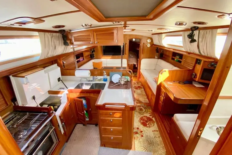Starlight Yacht Photos Pics Luxurious interior of 2016 Outbound 46 yacht with wood finish and modern amenities.