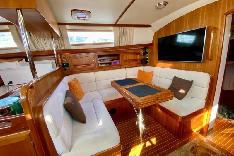 Starlight Yacht Photos Pics Luxurious interior of 2016 Outbound 46 yacht with cozy seating and elegant wood finish.