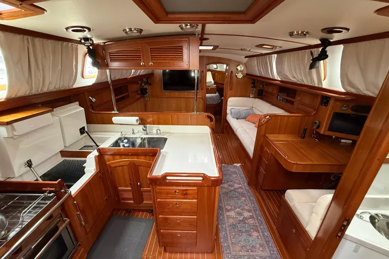 Starlight Yacht Photos Pics Luxurious 2016 Outbound 46 yacht interior with wood finish, spacious kitchen, and cozy seating area.
