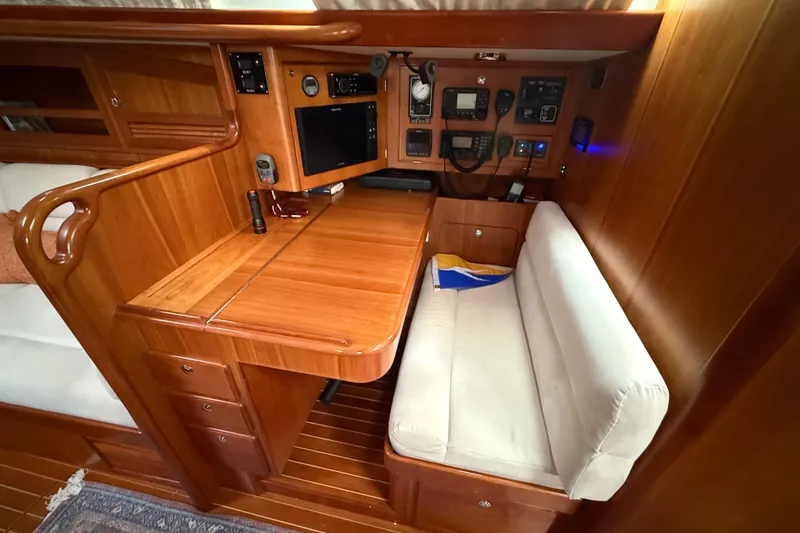 Starlight Yacht Photos Pics Luxurious 2016 Outbound 46 yacht interior with navigation station and wooden finish.