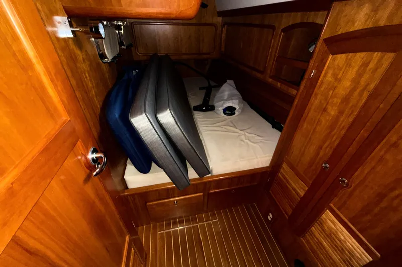 Starlight Yacht Photos Pics Cozy cabin interior of 2016 Outbound 46 yacht with wooden finish and bed.