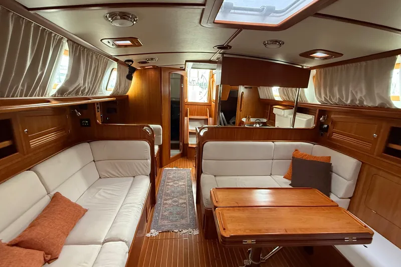 Starlight Yacht Photos Pics Luxurious interior of 2016 Outbound 46 yacht with elegant wood finish and comfortable seating.