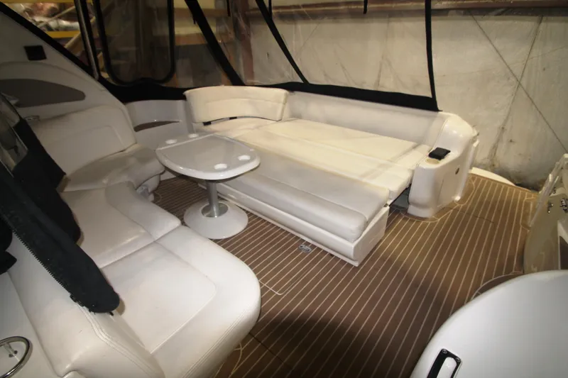 Broke R Yacht Photos Pics 1999 Sea Ray 460 Sundancer interior with white leather seating and small table.