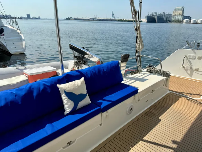 Confetti Yacht Photos Pics Luxurious 2016 Fountaine Pajot SABA 50 yacht deck with blue seating and scenic harbor view.