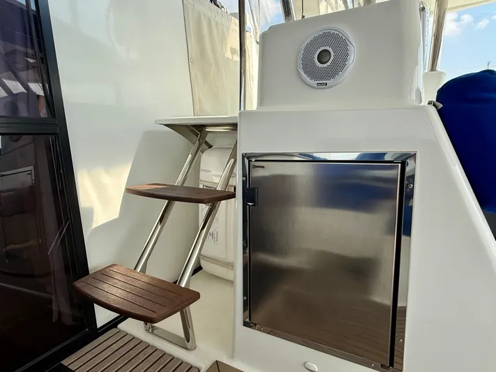 Confetti Yacht Photos Pics Stainless steel fridge and wooden steps on 2016 Fountaine Pajot SABA 50 yacht.