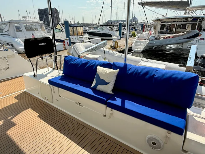 Confetti Yacht Photos Pics Luxury Fountaine Pajot SABA 50 yacht deck with blue seating, docked at marina.