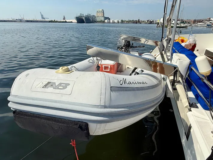 Confetti Yacht Photos Pics Inflatable dinghy attached to a 2016 Fountaine Pajot SABA 50 catamaran in a marina.