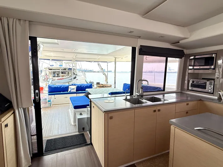 Confetti Yacht Photos Pics Interior of 2016 Fountaine Pajot SABA 50 yacht with kitchen and outdoor seating area.