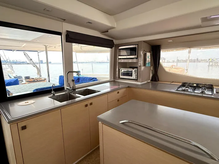 Confetti Yacht Photos Pics Modern kitchen interior of 2016 Fountaine Pajot SABA 50 catamaran with ocean view.