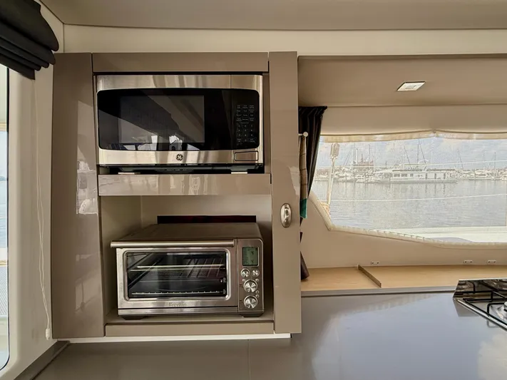 Confetti Yacht Photos Pics Modern kitchen appliances on 2016 Fountaine Pajot SABA 50 yacht, featuring microwave and toaster oven.