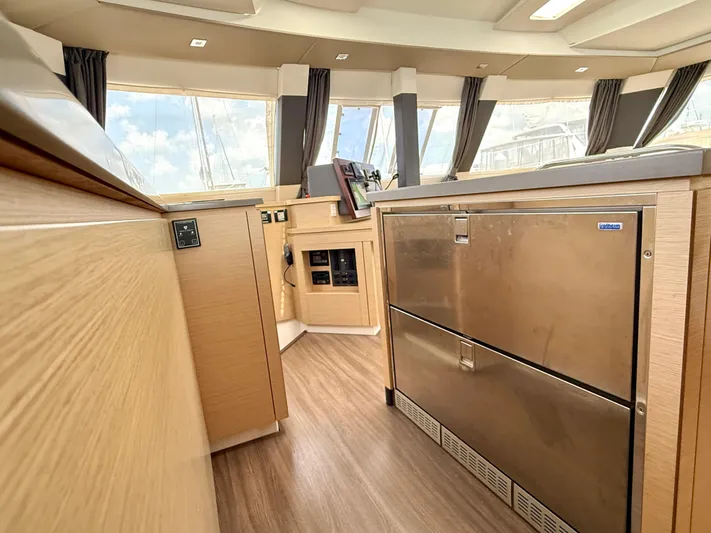 Confetti Yacht Photos Pics Interior of 2016 Fountaine Pajot SABA 50 yacht, featuring modern kitchen cabinetry and stainless steel appliances.