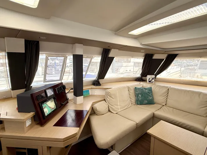 Confetti Yacht Photos Pics Interior of 2016 Fountaine Pajot SABA 50 yacht with beige seating and navigation station.