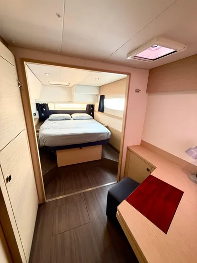 Confetti Yacht Photos Pics Luxurious cabin interior of 2016 Fountaine Pajot SABA 50 catamaran, featuring a cozy bed and desk.