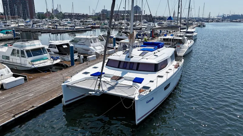 Confetti Yacht Photos Pics 2016 Fountaine Pajot SABA 50 catamaran docked in a marina with other boats.
