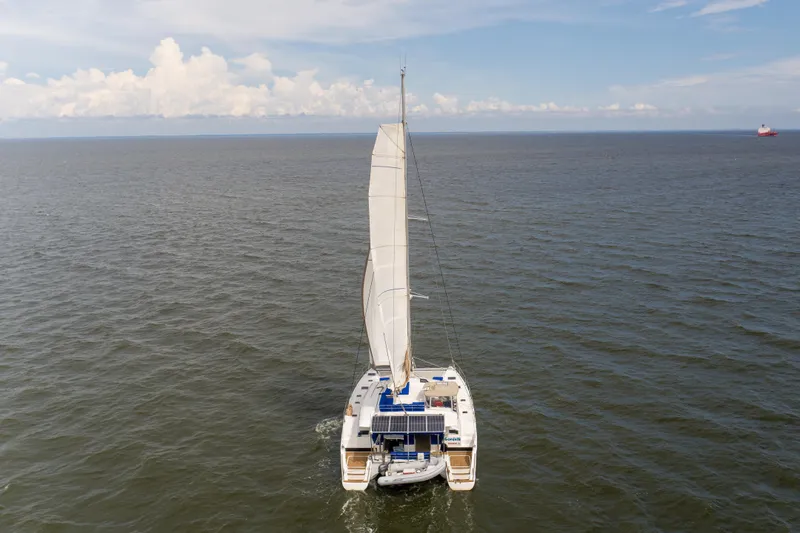 Confetti Yacht Photos Pics 2016 Fountaine Pajot SABA 50 catamaran sailing on open sea under clear skies.