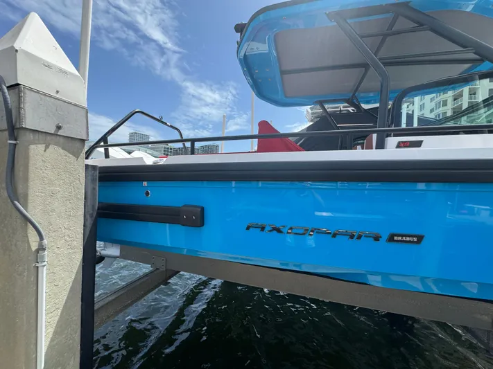  Yacht Photos Pics 2022 Axopar 28 T-top Aft Cabin Brabus Trim docked, showcasing sleek blue design.