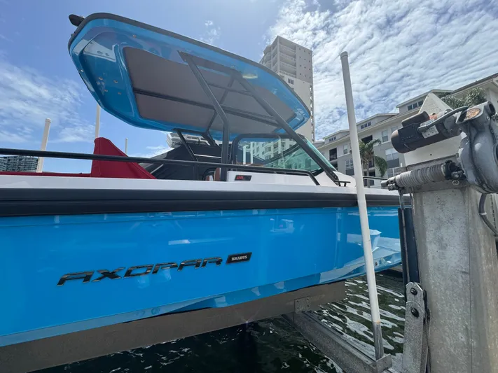  Yacht Photos Pics 2022 Axopar 28 T-top Aft Cabin Brabus Trim boat docked by waterfront.