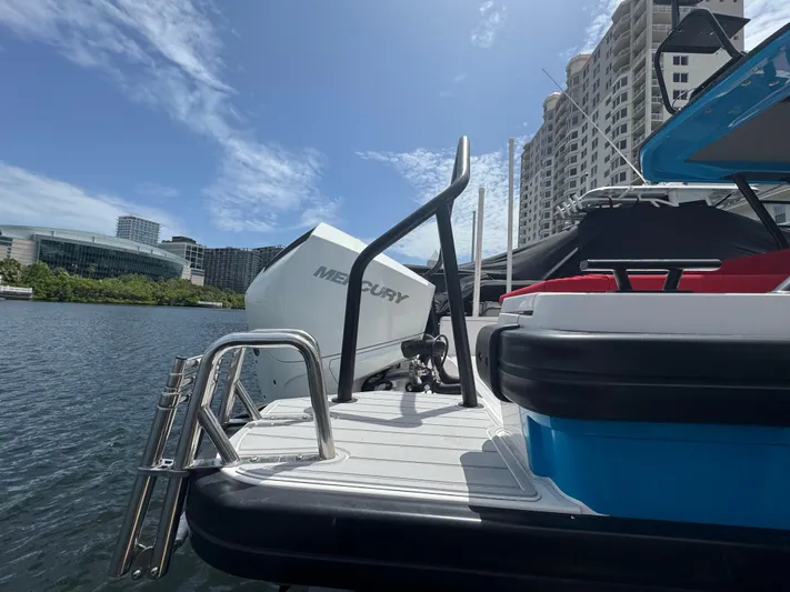  Yacht Photos Pics 2022 Axopar 28 T-top Aft Cabin Brabus Trim docked by waterfront buildings.