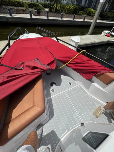  Yacht Photos Pics 2022 Axopar 28 T-top Aft Cabin Brabus Trim with red cover and tan seating.