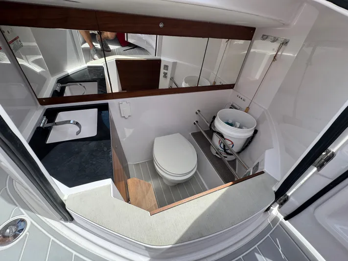  Yacht Photos Pics 2022 Axopar 28 T-top Aft Cabin Brabus Trim bathroom interior with modern fixtures and storage.