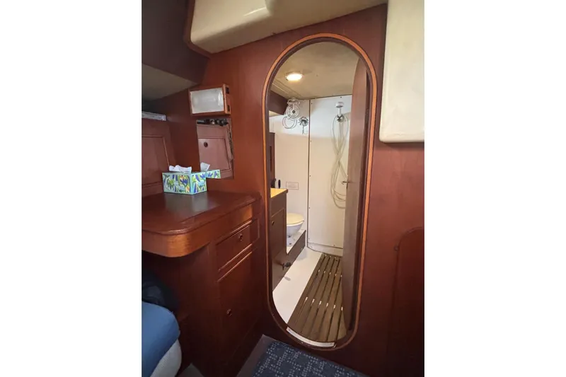 Prism Yacht Photos Pics Interior of 1984 Oyster 435 yacht showing bathroom and wooden cabinetry.
