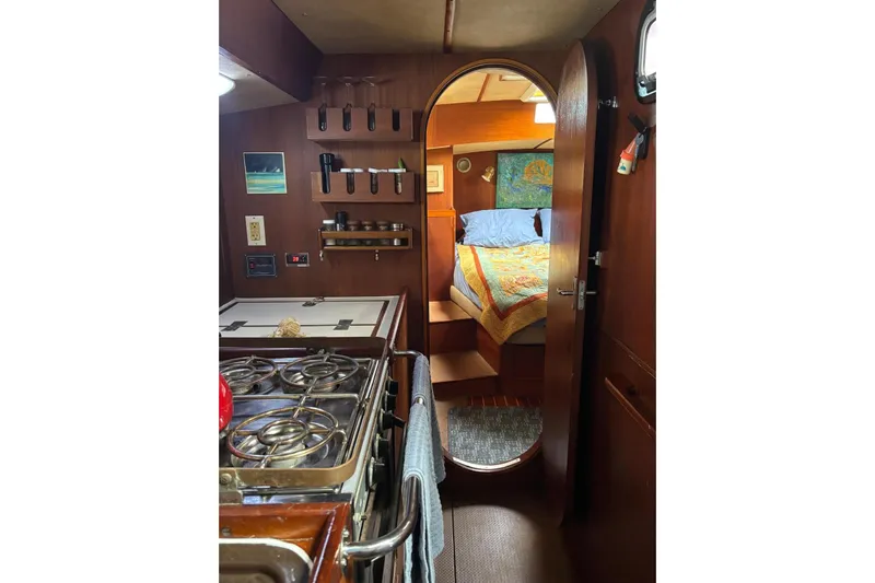 Prism Yacht Photos Pics Interior of a 1984 Oyster 435 yacht with kitchen and sleeping area.