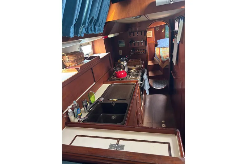 Prism Yacht Photos Pics 1984 Oyster 435 yacht interior with kitchen and cozy cabin view.