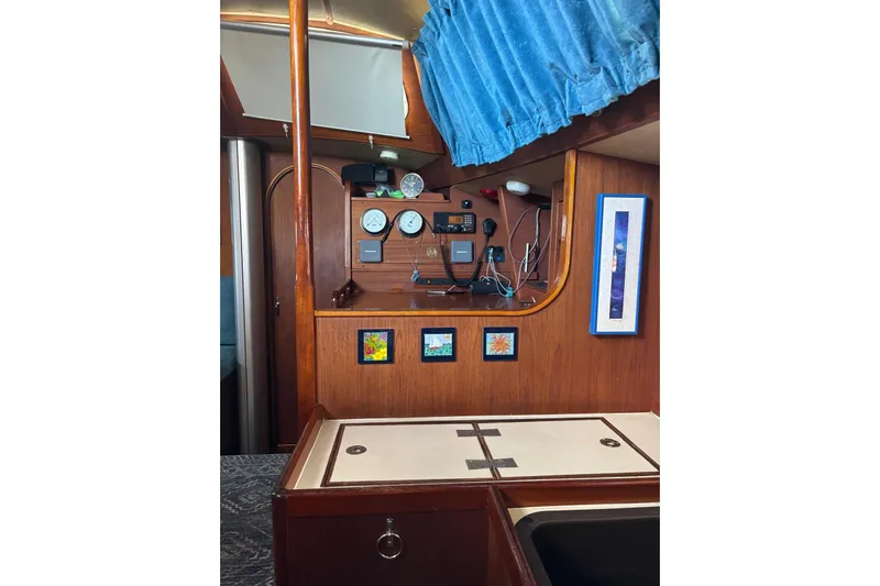 Prism Yacht Photos Pics Interior of 1984 Oyster 435 yacht with navigation instruments and wooden paneling.