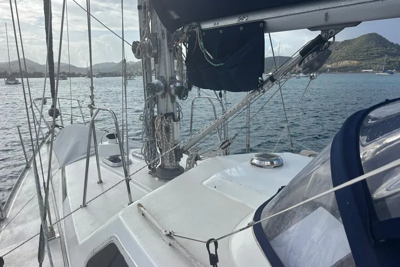 Prism Yacht Photos Pics 1984 Oyster 435 sailboat deck with rigging, anchored in scenic bay.